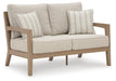 Hallow Creek Outdoor Loveseat with Cushion - CasaBella Furniture (San Antonio, TX)